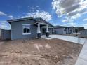 Charming single-story home with a concrete driveway and covered entrance, presenting a welcoming exterior at 4329 E Brook Lynn Pl, San Tan Valley, AZ 85143