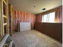 Interior view of a home under construction with unfinished flooring and pink insulation at 4329 E Brook Lynn Pl, San Tan Valley, AZ 85143
