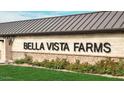 Close-up of the Bella Vista Farms sign, highlighting the modern design and meticulous landscaping at 4329 E Brook Lynn Pl, San Tan Valley, AZ 85143