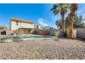 Spacious backyard featuring a refreshing private pool, rock landscaping and tall shade trees at 4343 E Contessa St, Mesa, AZ 85205