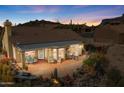 Aerial view of backyard with covered patio and desert landscaping perfect for outdoor relaxation at 4903 S Desert Willow Dr, Gold Canyon, AZ 85118