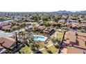 Expansive aerial view highlighting community pool, tile roofs, and mature trees at 5016 E Waltann Ln, Scottsdale, AZ 85254