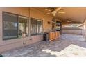 Covered patio with ceiling fans, built-in grill, counter space, and tiled flooring at 5016 E Waltann Ln, Scottsdale, AZ 85254