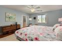 Bright bedroom featuring light blue walls, floral bedding, and a ceiling fan at 5206 N 16Th Dr, Phoenix, AZ 85015
