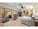 Spacious living room with tile floors, white sofa, and sliding glass doors to a backyard pool oasis at 5340 W Turquoise Ave, Glendale, AZ 85302