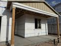 Close up exterior of covered front porch with wooden posts and a window at 5519 S 240Th Ln, Buckeye, AZ 85326