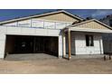 Exterior view of a partially constructed home showing the garage and covered porch at 5519 S 240Th Ln, Buckeye, AZ 85326