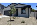 Charming single-story home featuring neutral paint, a two car garage and simple landscaping at 5519 S 240Th Ln, Buckeye, AZ 85326
