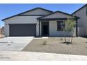 Charming single-story home featuring neutral paint, a two car garage and simple landscaping at 5519 S 240Th Ln, Buckeye, AZ 85326