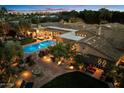 Backyard with a sparkling pool, an outdoor seating area, a patio with dining, and mature landscaping at 6402 E Chaparral Rd, Paradise Valley, AZ 85253