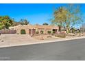Spacious home with a Southwestern design, mature landscaping, a circular driveway, and a two-car garage at 902 W Moon Valley Dr, Phoenix, AZ 85023