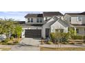 Attractive two-story home showcasing a sleek garage door and appealing front yard landscaping at 10150 E Thistle Ave, Mesa, AZ 85212