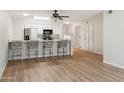 Modern kitchen with granite counters, stainless steel appliances, and adjacent breakfast bar seating at 1021 S Greenfield Rd # 1106, Mesa, AZ 85206