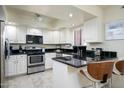 Modern kitchen featuring stainless steel appliances, white cabinets, and sleek black countertops at 12212 N Paradise Village S Pkwy # 444, Phoenix, AZ 85032