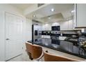 Updated kitchen boasts stainless steel appliances, dark countertops, and white cabinetry at 12212 N Paradise Village S Pkwy # 444, Phoenix, AZ 85032