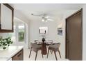 Cozy dining area with a round table, four chairs, and natural light from a window at 12939 W Prospect Dr, Sun City West, AZ 85375