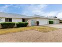 Charming single-story home with a two-car garage, manicured bushes, and small decorative entry gate at 12939 W Prospect Dr, Sun City West, AZ 85375