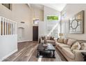 Spacious living room with vaulted ceilings, hardwood floors, and fireplace at 16044 N 106Th Way, Scottsdale, AZ 85255