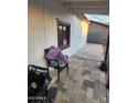 Charming outdoor patio area featuring a stylish stone tile floor, offering a cozy spot to relax and enjoy the scenery at 1618 S Cedar Dr, Apache Junction, AZ 85120