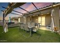 Inviting backyard patio with a pergola, string lights, outdoor furniture, and a relaxing hot tub at 17145 W Hadley St, Goodyear, AZ 85338