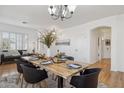 Inviting dining room with seating for six, complemented by a modern chandelier and bright, natural light at 1775 W Green Tree Dr, San Tan Valley, AZ 85144