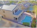 Aerial view of home showcasing a spacious backyard, refreshing pool, and solar panels at 18346 W Sweet Acacia Dr, Goodyear, AZ 85338