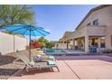 Inviting backyard with refreshing pool, lounge chairs, and a serene outdoor dining area at 18346 W Sweet Acacia Dr, Goodyear, AZ 85338