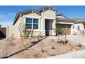 Close-up view of a single-story home featuring desert landscaping and a visible two-car garage at 25364 W Sunland Ave, Buckeye, AZ 85326