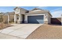 Exterior of home with two car garage, low-maintenance desert landscaping, and modern architectural details at 25431 W Graham Trl, Buckeye, AZ 85326