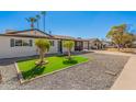 Beautiful home with a vibrant green lawn, desert landscaping, and charming curb appeal at 3315 W Shaw Butte Dr, Phoenix, AZ 85029