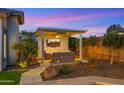 Cozy outdoor lounge area with a mounted TV, comfortable seating, and ambient lighting for relaxation at 3953 E Lafayette Ave, Gilbert, AZ 85298