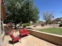 Inviting outdoor patio seating area surrounded by lush landscaping and natural light at 4750 W Saddlehorn Rd, Phoenix, AZ 85083