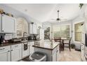 Bright kitchen with white cabinets, an island, granite countertops, and an eat-in area at 5622 E Gelding Dr, Scottsdale, AZ 85254
