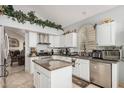 Kitchen featuring island, tile floors, stainless steel appliances, and granite countertops at 5622 E Gelding Dr, Scottsdale, AZ 85254