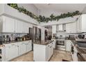 Bright kitchen featuring stainless steel appliances, tile floors, granite countertops, and island at 5622 E Gelding Dr, Scottsdale, AZ 85254