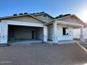 New construction home exterior featuring a spacious two-car garage and covered porch framing in progress at 5631 W Summerside Rd, Laveen, AZ 85339