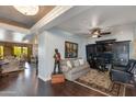 Stylish living room featuring hardwood floors, modern lighting, and a separate office nook with built-ins at 7181 E Camelback Rd # 208, Scottsdale, AZ 85251
