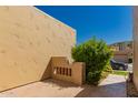 Desert home exterior featuring a private courtyard with lush greenery and stucco walls at 7955 E Chaparral Rd # 120, Scottsdale, AZ 85250