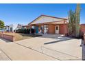 Charming single-story brick home featuring a covered porch and carport, surrounded by desert landscaping at 8107 E Mitchell Dr, Scottsdale, AZ 85251