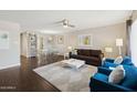 Bright living room featuring modern furniture, dark wood flooring and a stylish ceiling fan at 8107 E Mitchell Dr, Scottsdale, AZ 85251