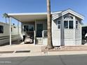 Attractive property featuring a covered parking area and a quaint, well-maintained front yard at 903 S Mineshaft Dr, Apache Junction, AZ 85119