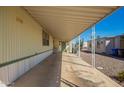 Extended carport area providing ample covered parking and access to the home's entrance at 9828 E Pueblo Ave # 113, Mesa, AZ 85208