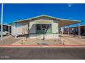 Welcoming single-story home featuring covered parking, a well-manicured yard, and desert landscaping at 9828 E Pueblo Ave # 113, Mesa, AZ 85208