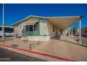 Inviting single-story home with covered parking, attractive desert landscaping, and a convenient layout at 9828 E Pueblo Ave # 113, Mesa, AZ 85208