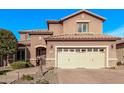 Inviting two-story home with a beige garage door, tile roof, desert landscaping, and stone veneer accents at 10746 W Desert Elm Ln, Peoria, AZ 85383