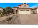 Beautiful two-story home with a spacious driveway, manicured landscaping, desert accents, and a beige garage door at 10746 W Desert Elm Ln, Peoria, AZ 85383