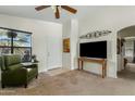 Cozy living room featuring a green leather recliner, a ceiling fan, and neutral carpeting at 1433 E Indian Wells Dr, Chandler, AZ 85249