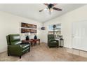 Comfortable living room features two green leather recliners and natural light from the window at 1433 E Indian Wells Dr, Chandler, AZ 85249