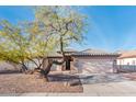 Charming home exterior with desert landscaping and a two-car garage at 16292 N Naegel Dr, Surprise, AZ 85374