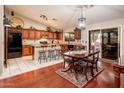 Open kitchen with granite countertops, breakfast bar, and dark wood cabinetry at 16292 N Naegel Dr, Surprise, AZ 85374